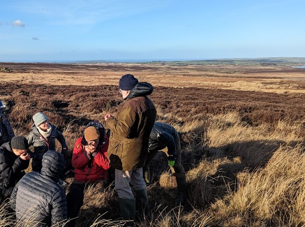 ©Ellie Davison, identifying moss species in the field.